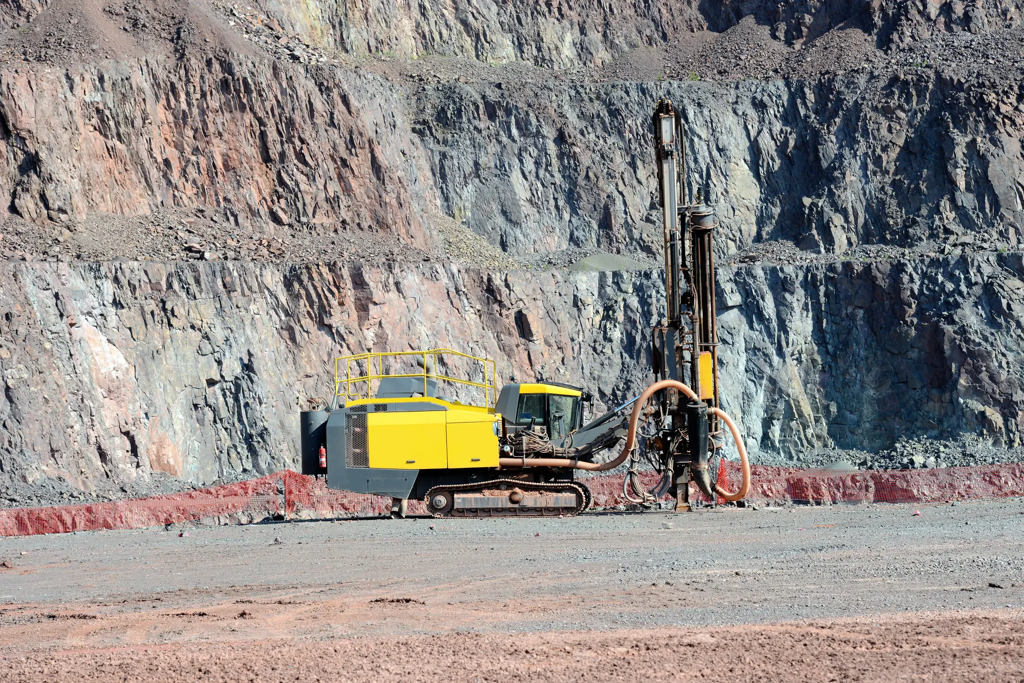Drilling rig operating in an open pit mine
